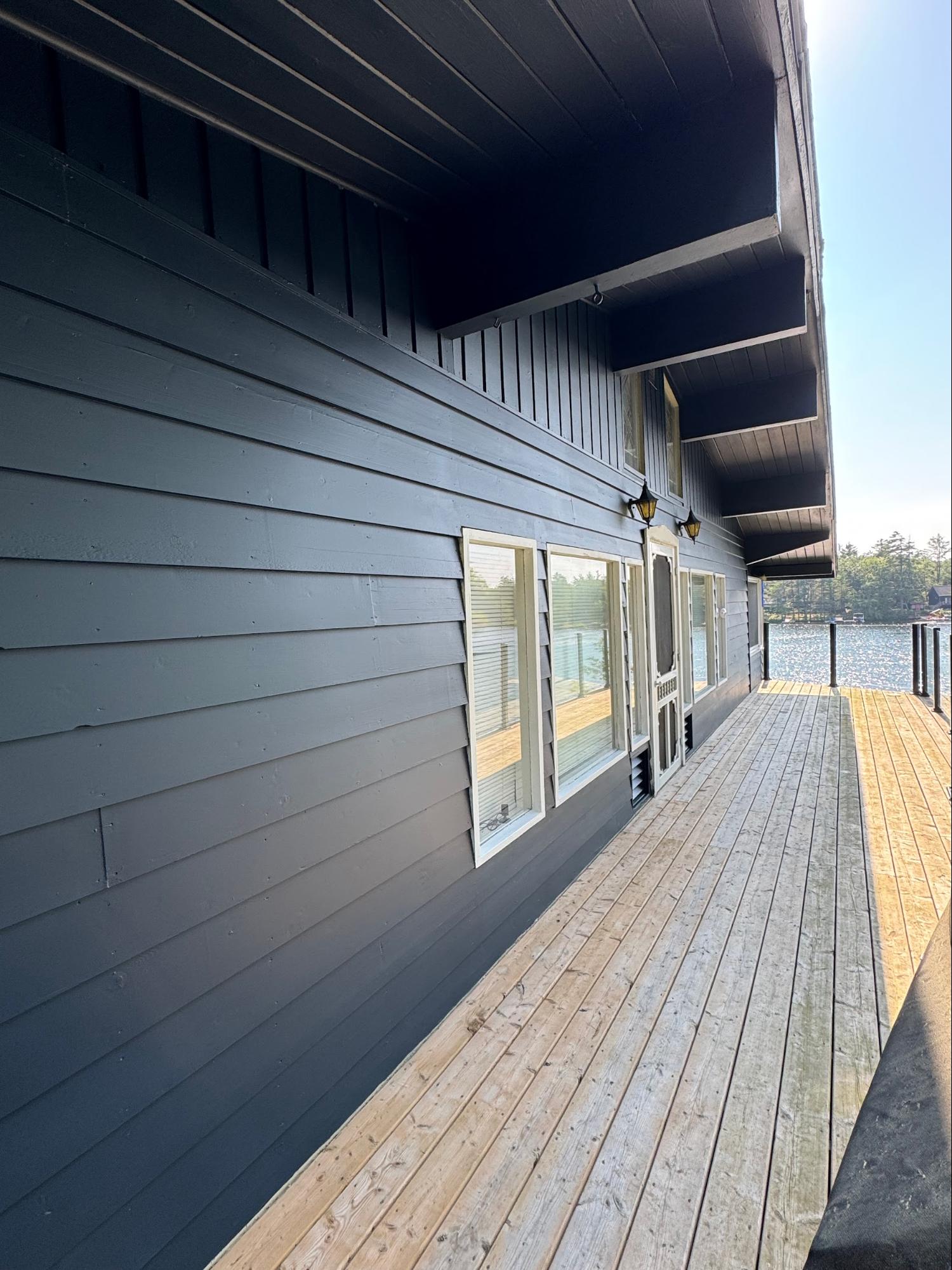 Lakeside boathouse with exterior painting and deck
